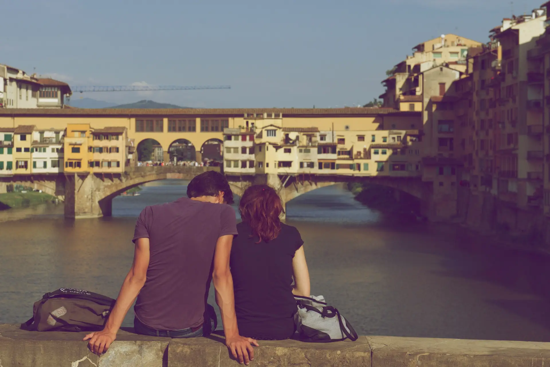 couple sitting on bridge in Florence